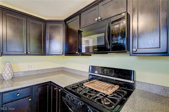 kitchen with black microwave, light countertops, dark brown cabinetry, and range with gas stovetop