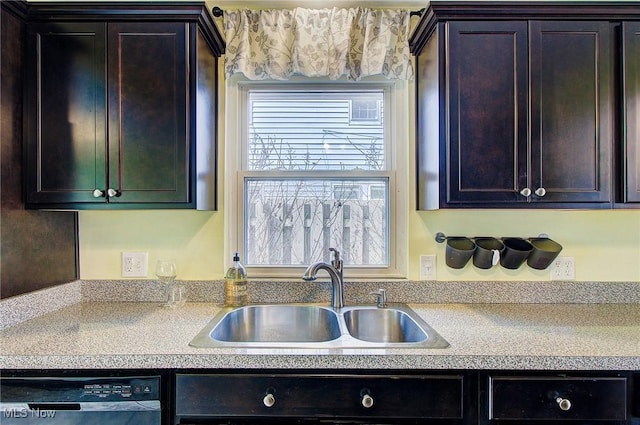 kitchen featuring dishwashing machine, dark brown cabinets, light countertops, and a sink