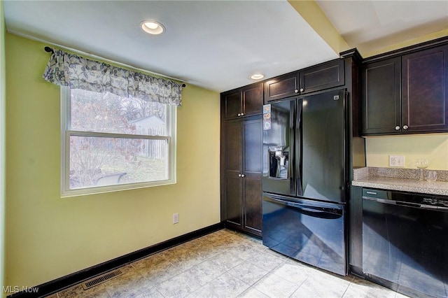 kitchen with light countertops, visible vents, dark brown cabinetry, black appliances, and baseboards