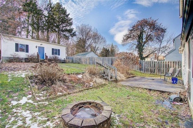 view of yard with a patio area, an outdoor fire pit, and fence