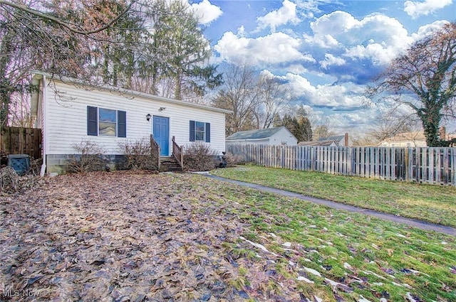 exterior space featuring a front lawn and fence