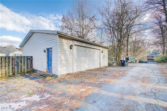 detached garage featuring fence