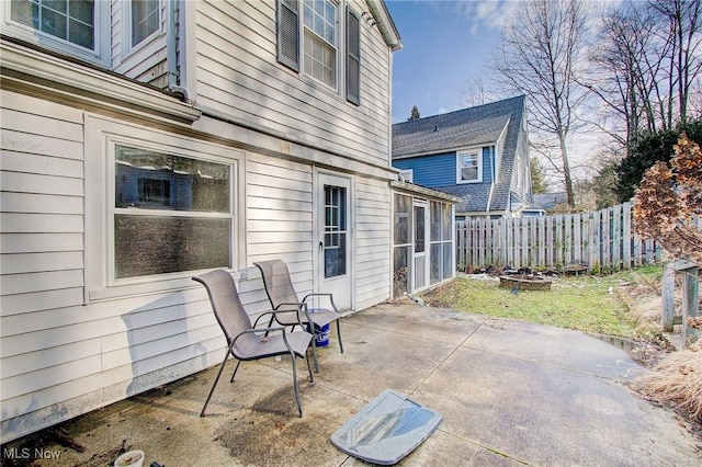 view of patio / terrace with an outdoor fire pit and fence