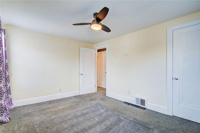 unfurnished bedroom with carpet, visible vents, baseboards, and ceiling fan