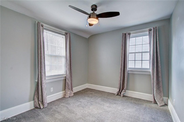 spare room featuring carpet floors, baseboards, and a ceiling fan