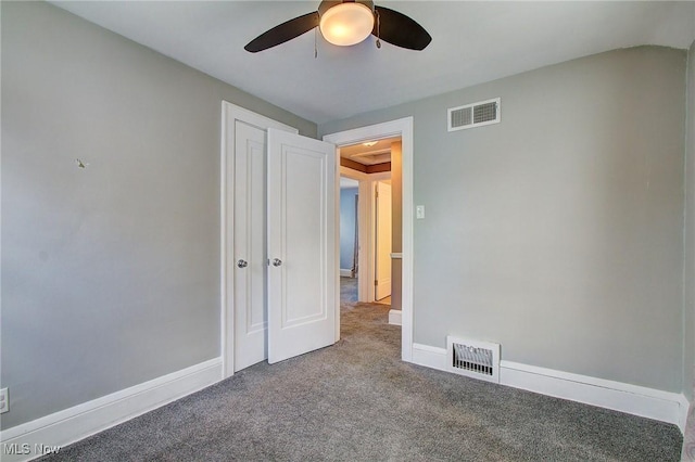 unfurnished bedroom with baseboards, visible vents, and carpet flooring