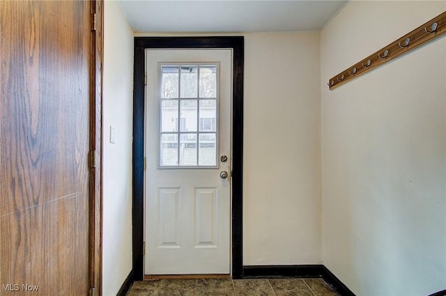 doorway to outside with baseboards