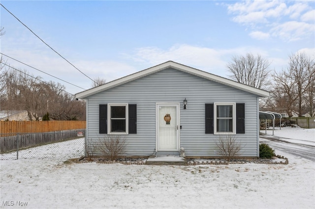 bungalow-style house with fence