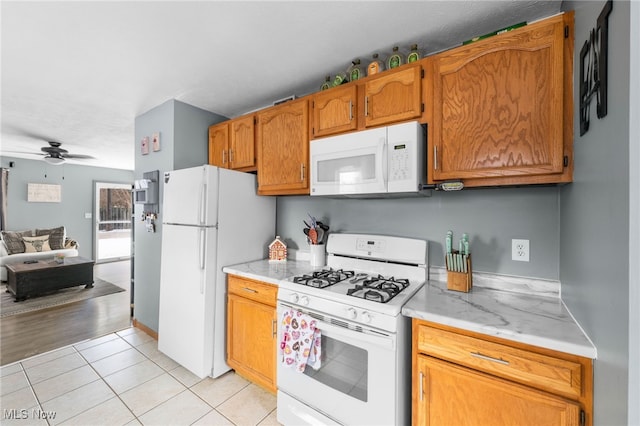 kitchen featuring light countertops, white appliances, light tile patterned flooring, and ceiling fan