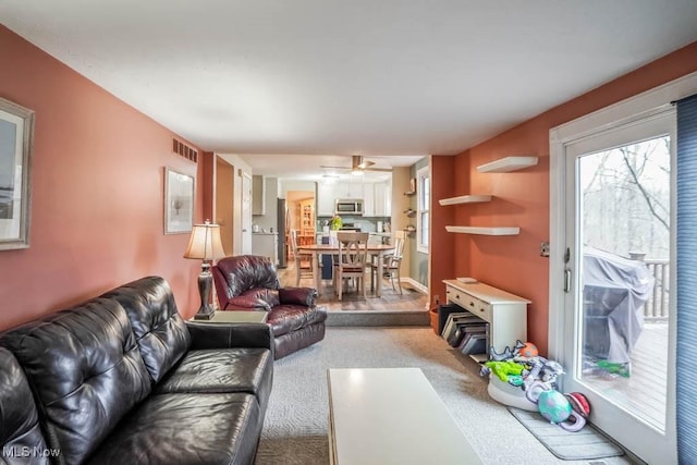 carpeted living area with visible vents