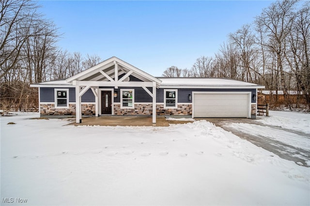 view of front of property with stone siding and an attached garage