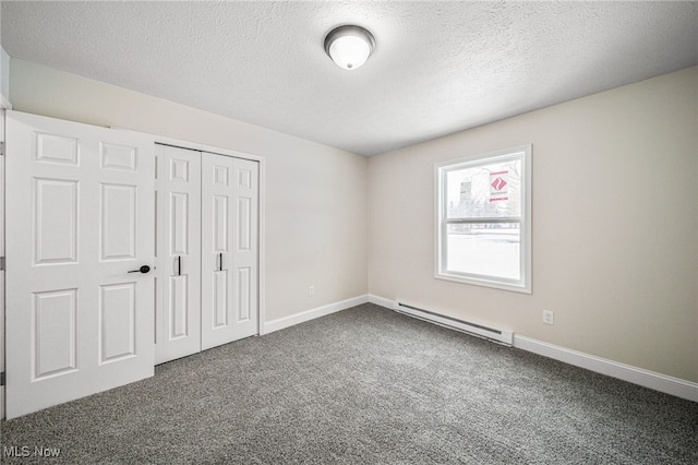 unfurnished bedroom featuring carpet floors, a closet, a baseboard radiator, and baseboards