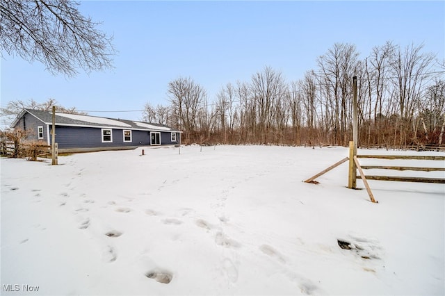 snowy yard with a garage