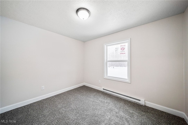 carpeted spare room with baseboards, a baseboard heating unit, and a textured ceiling