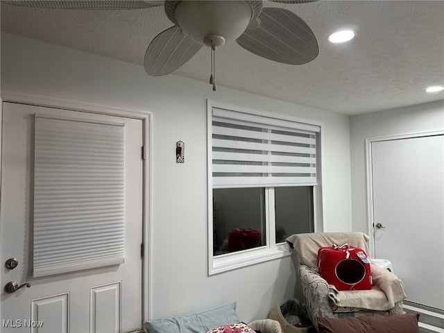 interior details featuring ceiling fan, a textured ceiling, and recessed lighting