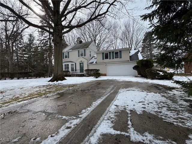 view of front of house with a chimney and an attached garage