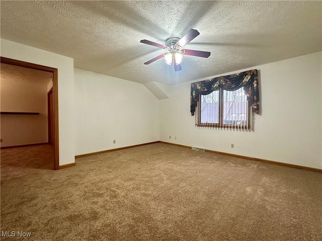 additional living space featuring baseboards, visible vents, and carpet flooring