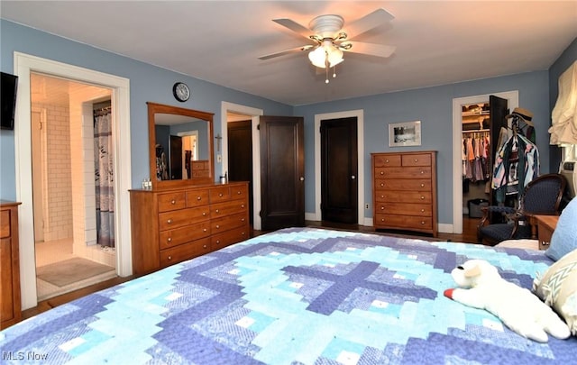 bedroom with ceiling fan, connected bathroom, and a walk in closet