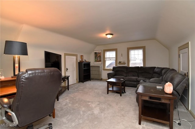 living area featuring light colored carpet and vaulted ceiling