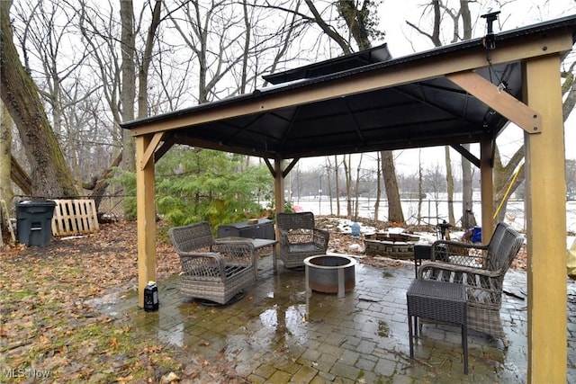 view of patio / terrace featuring fence, a fire pit, and a gazebo