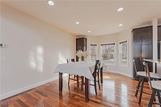 dining room with recessed lighting, light wood-type flooring, and baseboards