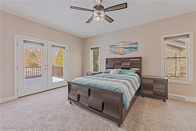 carpeted bedroom featuring access to outside, french doors, multiple windows, and baseboards