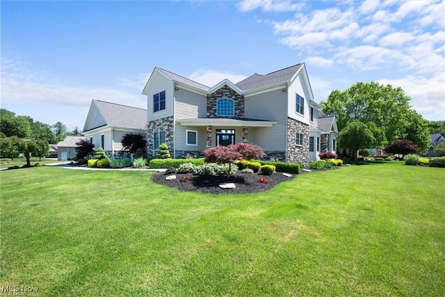 view of front of home featuring a front yard and stone siding