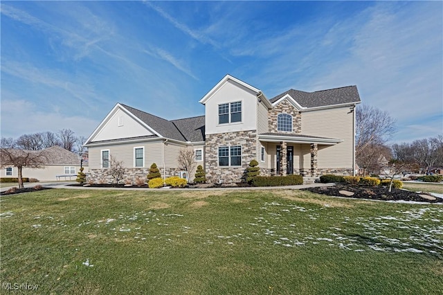 view of front of house with stone siding and a front lawn