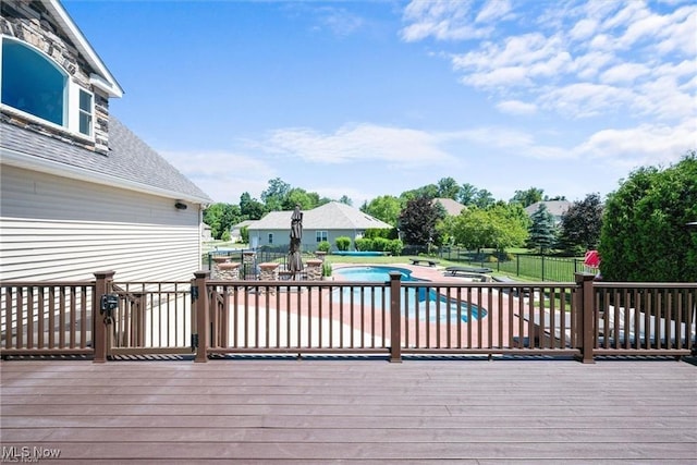 wooden terrace with a patio area, fence, a fenced in pool, and a hot tub