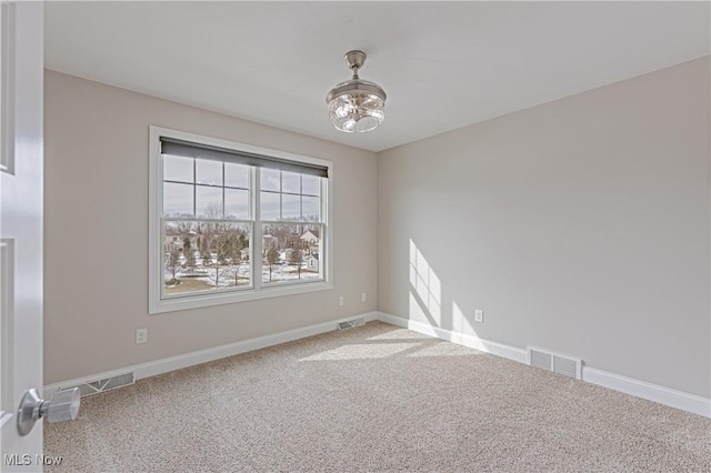 unfurnished room with visible vents and baseboards