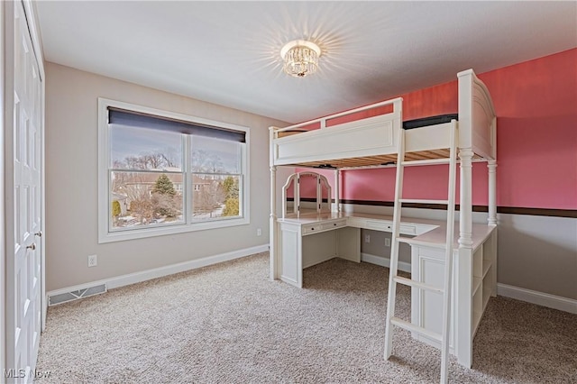 unfurnished bedroom featuring carpet floors, visible vents, and baseboards