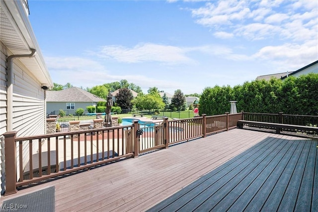 deck with a fenced in pool, a patio, and fence