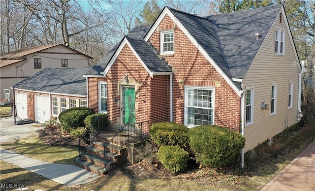 view of front of house with brick siding, an attached garage, and roof with shingles