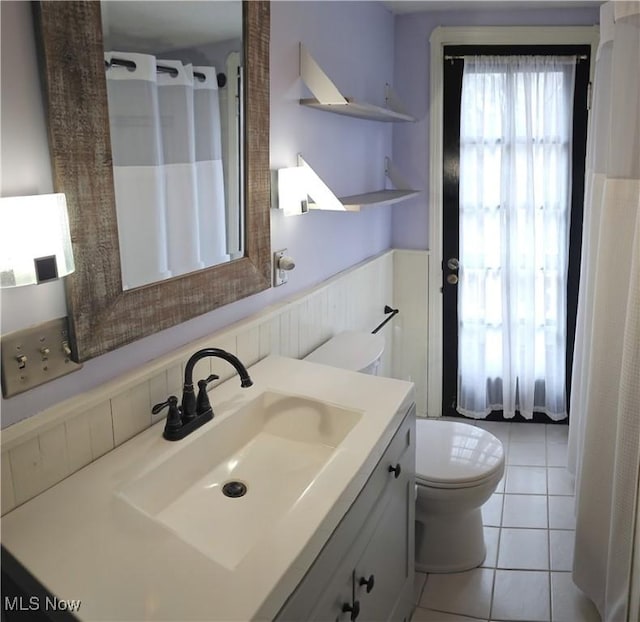 bathroom with vanity, a shower with shower curtain, tile patterned flooring, and toilet