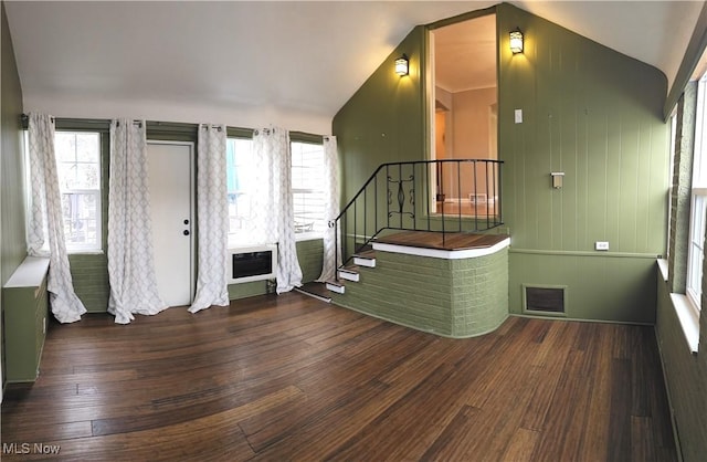 entrance foyer featuring wood finished floors, visible vents, stairs, vaulted ceiling, and heating unit