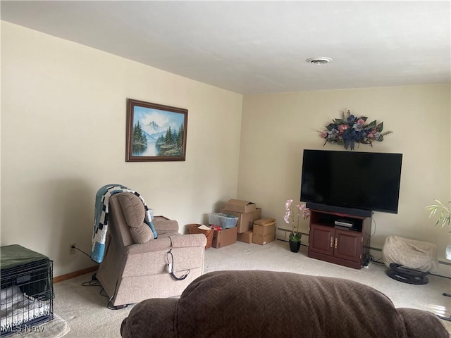 living area with light carpet, a baseboard radiator, and visible vents