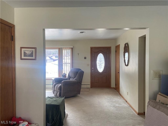 foyer featuring light carpet, baseboards, and baseboard heating