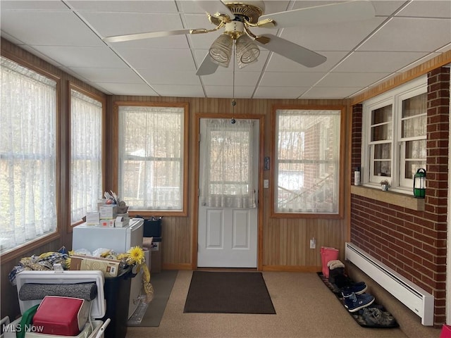 sunroom / solarium featuring a baseboard heating unit, a drop ceiling, and ceiling fan