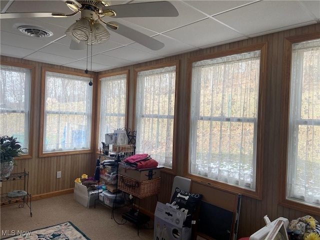 sunroom featuring a paneled ceiling, visible vents, plenty of natural light, and ceiling fan