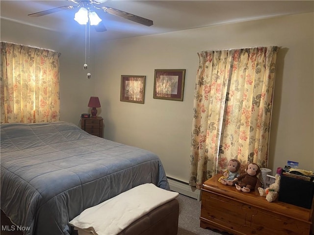 bedroom with carpet, ceiling fan, and a baseboard radiator