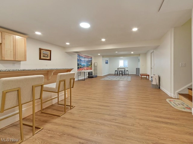 interior space with light wood-type flooring, stairs, baseboards, and recessed lighting