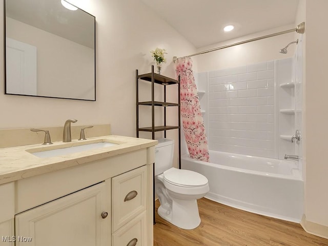 bathroom featuring shower / bath combo, vanity, toilet, and wood finished floors