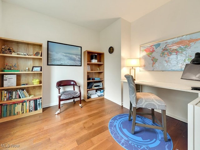 home office with wood finished floors and baseboards