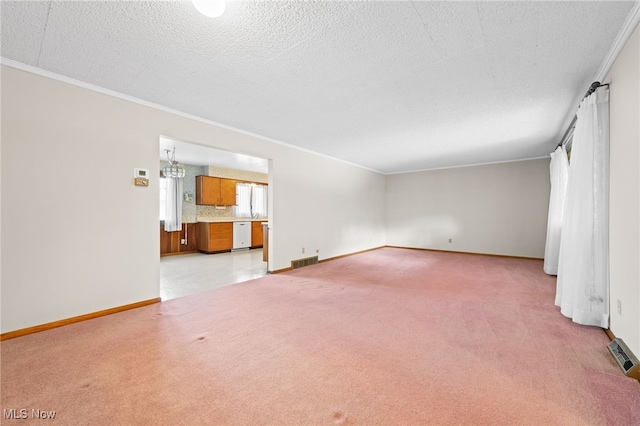 unfurnished living room with light carpet, visible vents, and a textured ceiling