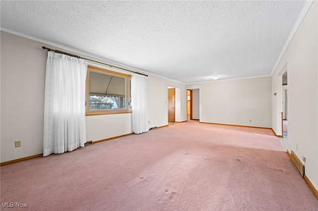 unfurnished room with carpet, baseboards, and crown molding