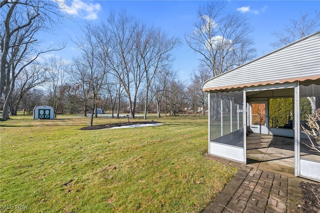 view of yard featuring an outbuilding, a sunroom, and a shed