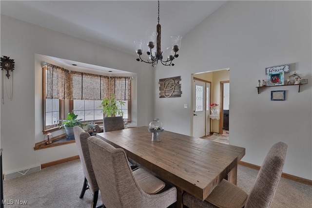 dining area with light carpet, an inviting chandelier, baseboards, and visible vents