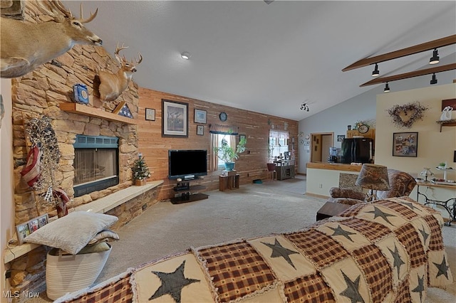 living room with high vaulted ceiling, carpet, and a fireplace