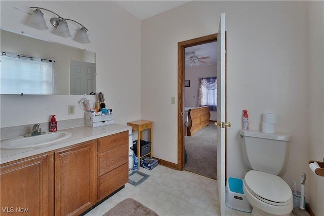 bathroom with baseboards, vanity, toilet, and tile patterned floors