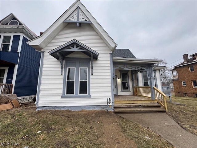 view of front of house featuring a porch and roof with shingles